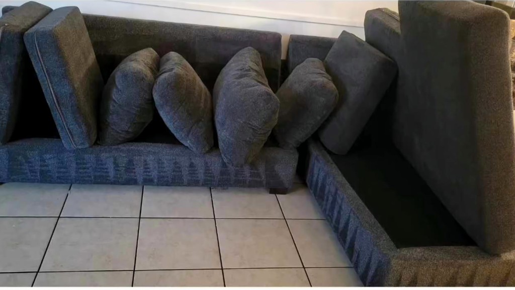 Family sectional sofa with accumulated dirt and oils before cleaning